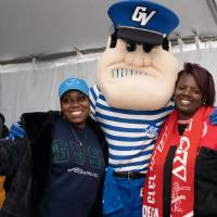 louie poses for picture with two women